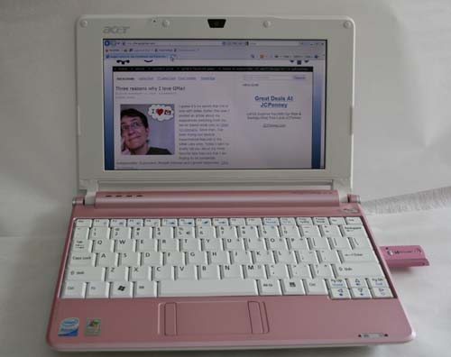 a small laptop where the top half is white and the bottom half is pink. The keys are white.