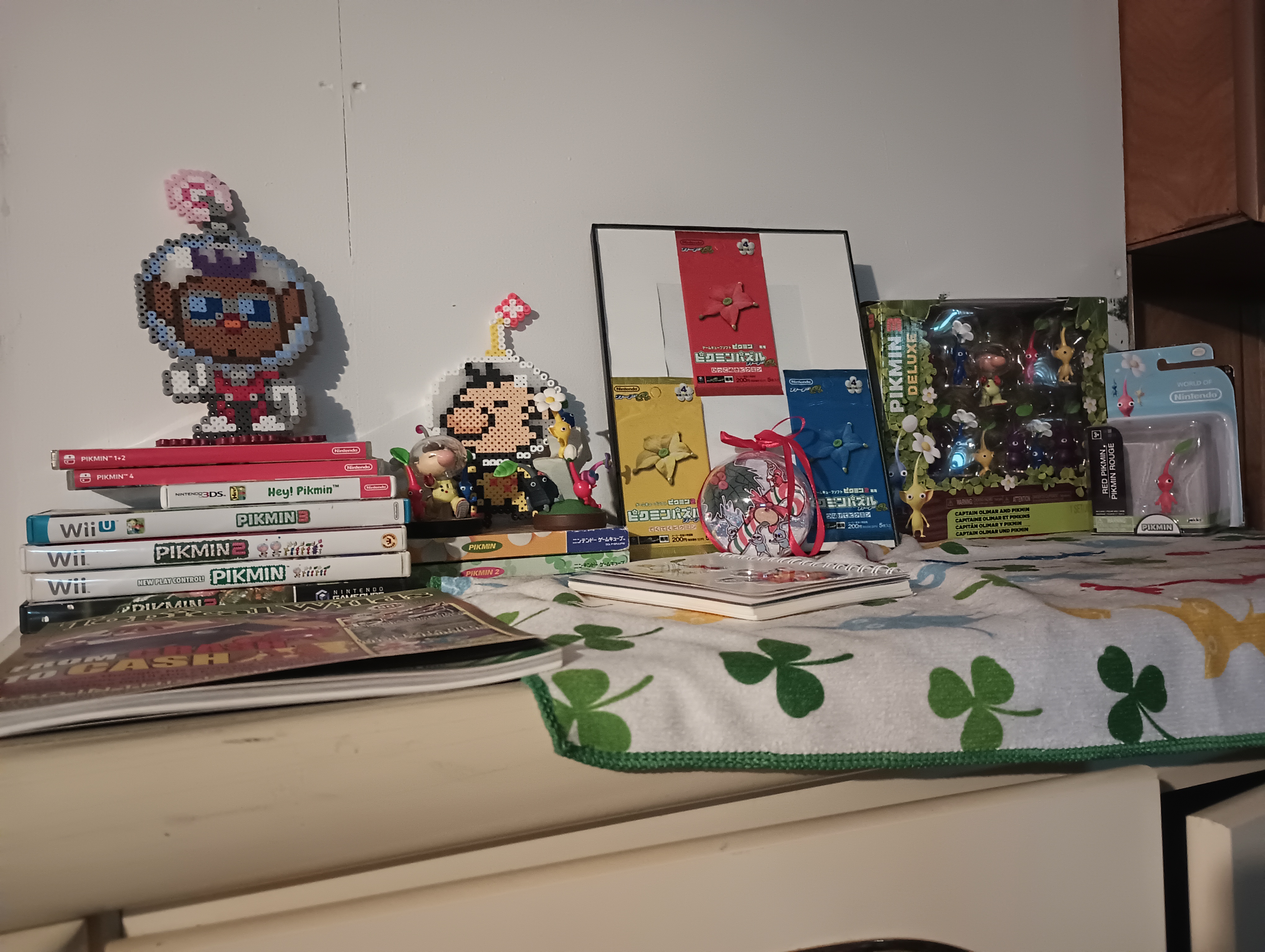 photo of a shelf covered in pikmin merch and art.